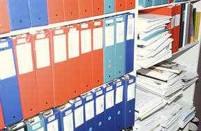 Photo of files and binders in a shelf